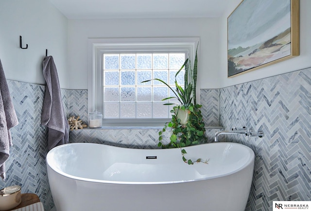 bathroom with a bathtub and tile walls