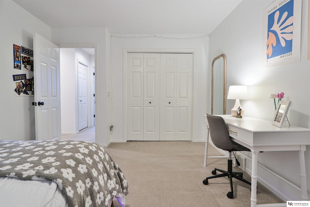 bedroom with a closet and light carpet