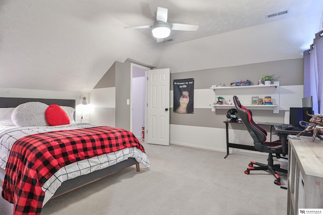 bedroom featuring a textured ceiling, ceiling fan, light colored carpet, and lofted ceiling