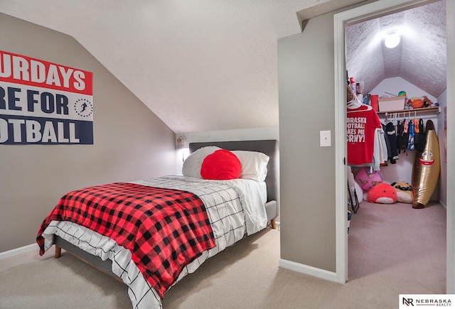 carpeted bedroom featuring a closet and lofted ceiling