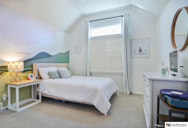 carpeted bedroom featuring a textured ceiling and vaulted ceiling