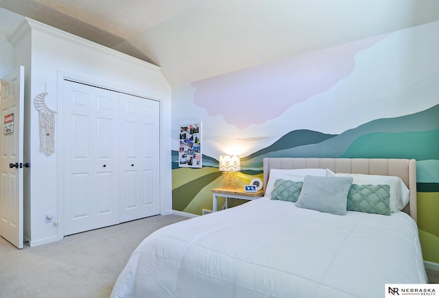 bedroom featuring a closet, vaulted ceiling, and light carpet