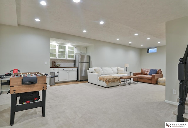 living room featuring light colored carpet and a textured ceiling