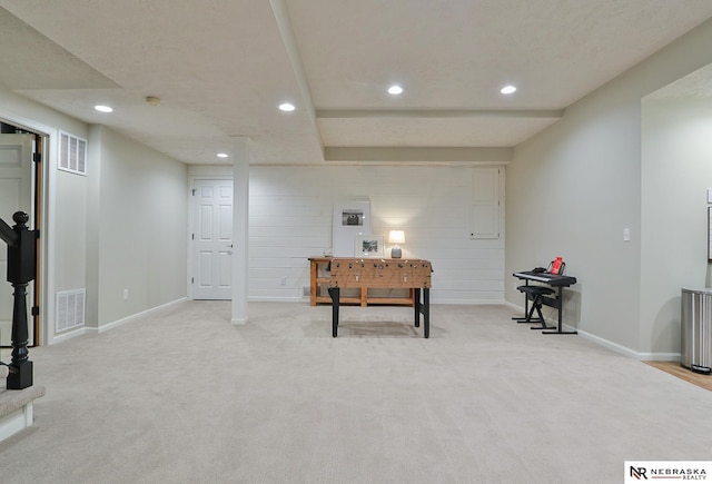 interior space with light colored carpet and a textured ceiling