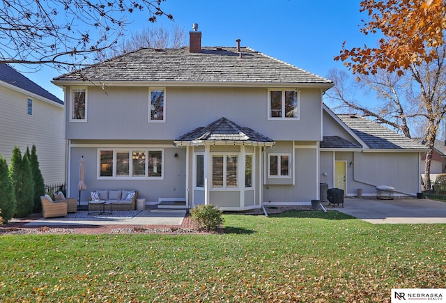 back of property with a patio area, a yard, and an outdoor hangout area