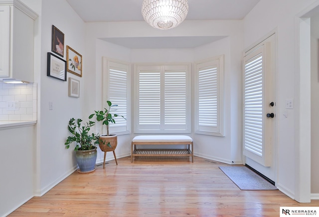 interior space with a chandelier and light hardwood / wood-style floors