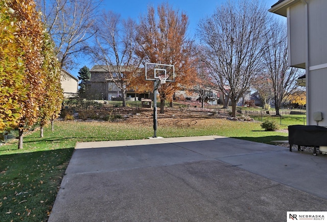 view of basketball court featuring a lawn