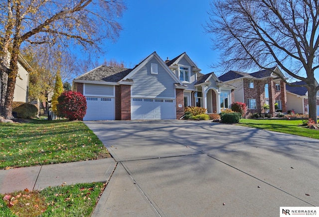 view of front of house with a front yard and a garage