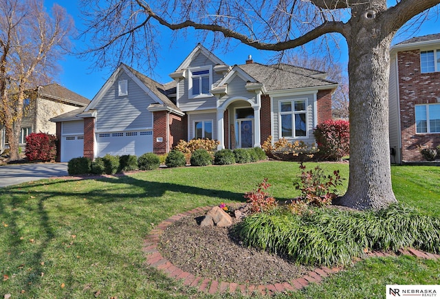 view of front of house featuring a garage and a front lawn