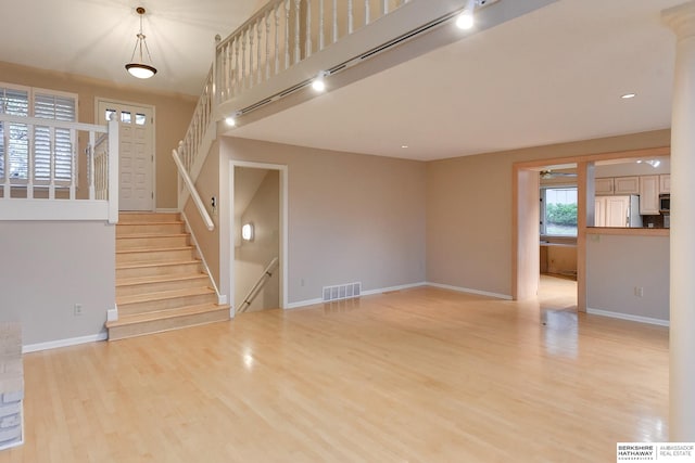 interior space featuring light hardwood / wood-style floors and rail lighting