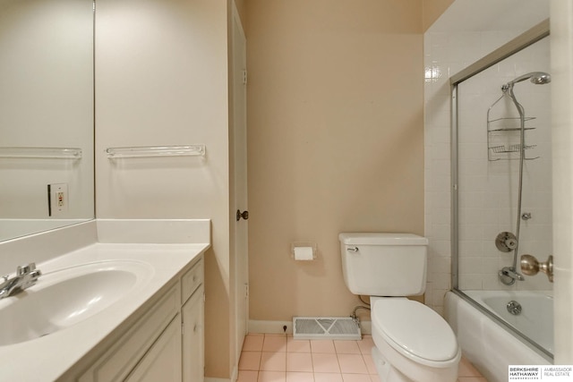 full bathroom featuring enclosed tub / shower combo, vanity, tile patterned floors, and toilet