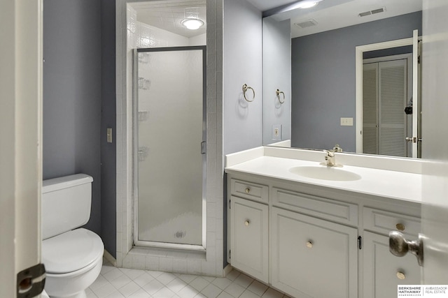 bathroom with vanity, toilet, tile patterned floors, and a shower with shower door