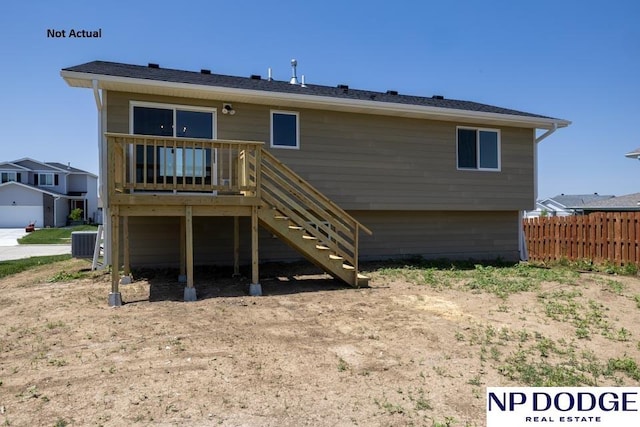 rear view of property featuring a deck and central AC unit