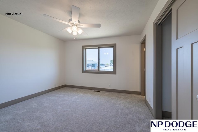 unfurnished bedroom featuring ceiling fan, carpet, and a textured ceiling