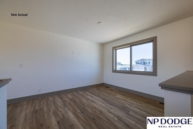 interior space with dark wood-type flooring and a textured ceiling