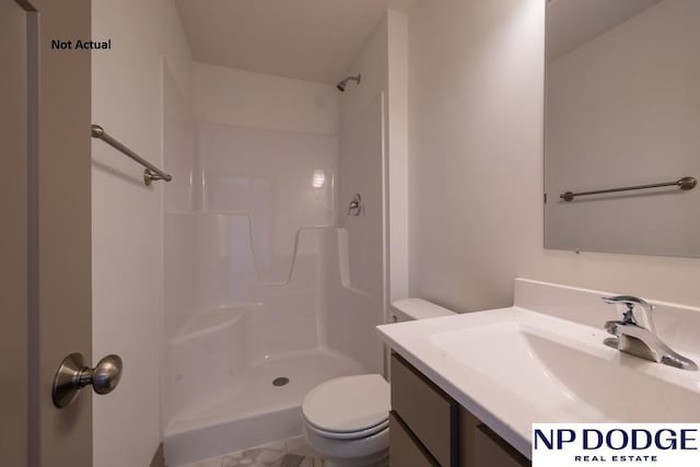 bathroom with a shower, vanity, and toilet