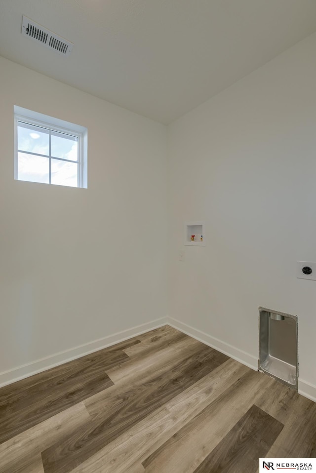 laundry room with washer hookup, wood-type flooring, and electric dryer hookup