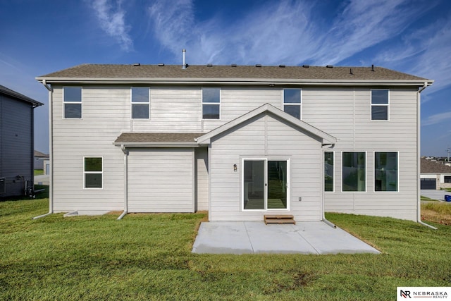 back of house featuring a lawn and a patio area