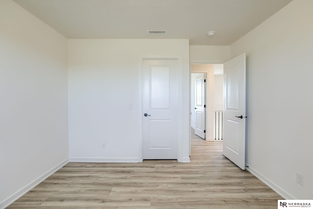 unfurnished bedroom with light wood-type flooring