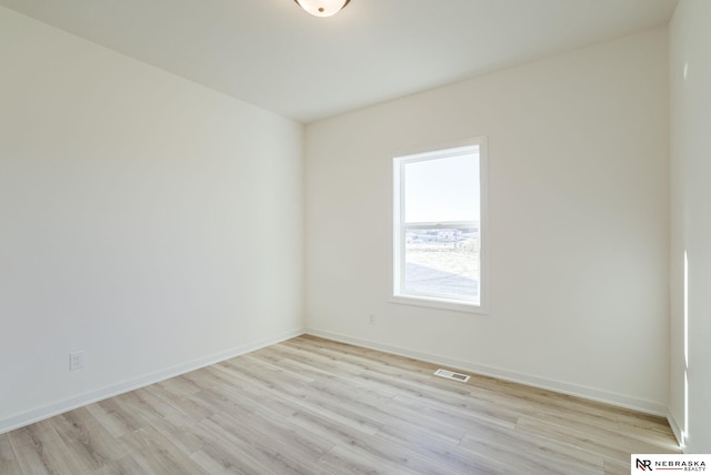 empty room with light hardwood / wood-style flooring