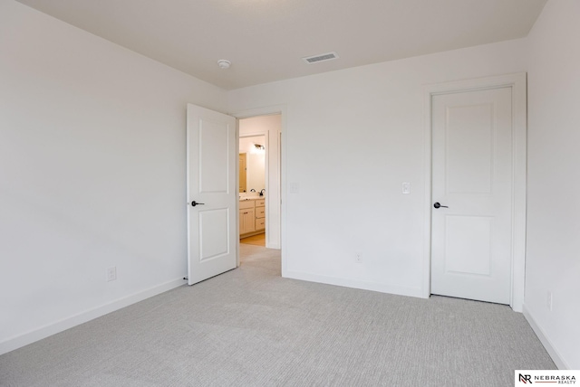 unfurnished bedroom featuring light colored carpet