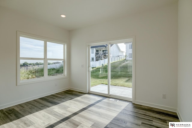 unfurnished room with hardwood / wood-style flooring