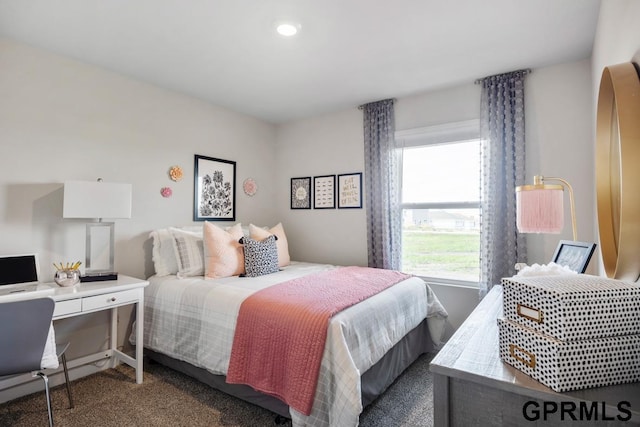 bedroom featuring dark colored carpet