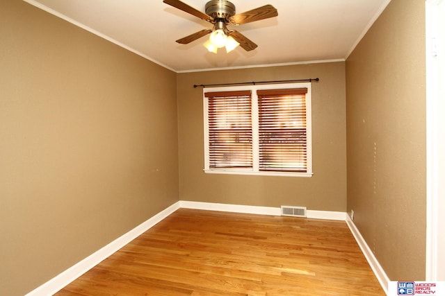 spare room featuring light wood-type flooring, ceiling fan, and ornamental molding