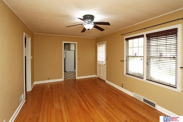 unfurnished room with ceiling fan, ornamental molding, and hardwood / wood-style flooring