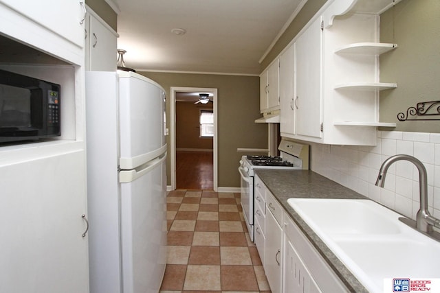 kitchen featuring tasteful backsplash, white appliances, crown molding, sink, and white cabinets