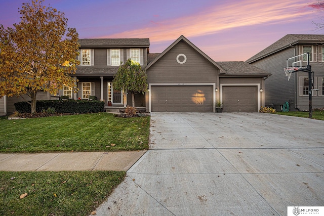 view of front of house featuring a lawn and a garage