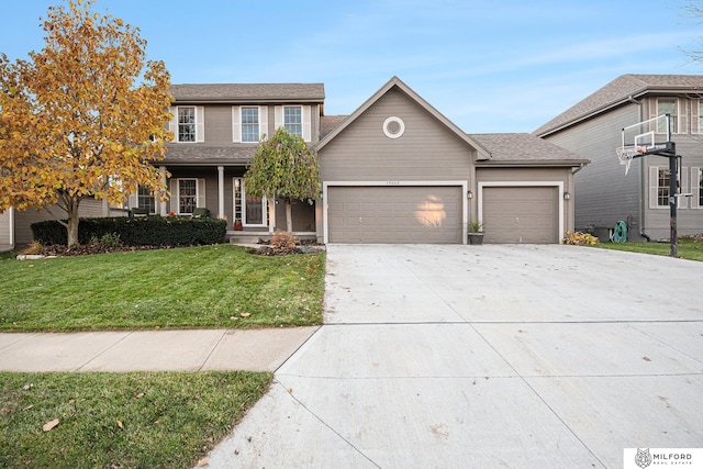 view of front facade with a garage and a front lawn