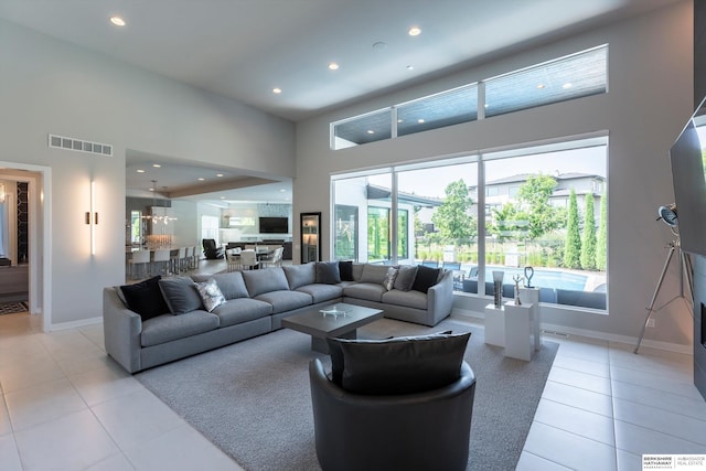 tiled living room with a towering ceiling