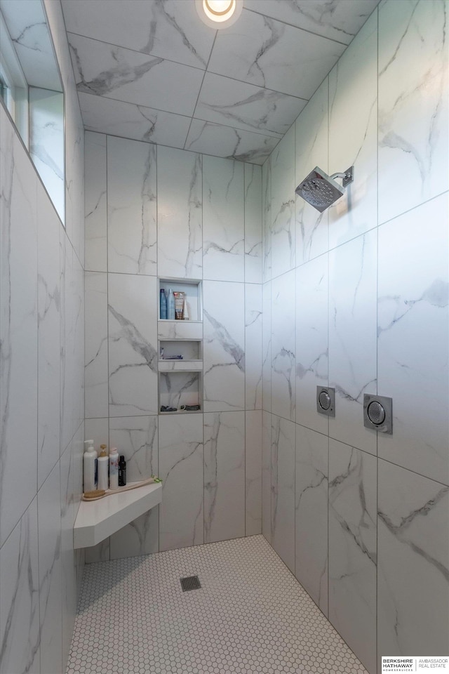 bathroom with a tile shower