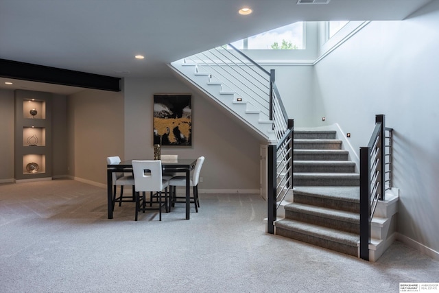 stairway featuring carpet