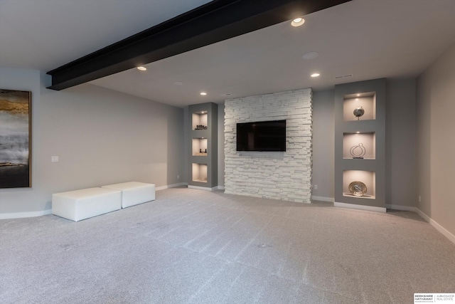 unfurnished living room with beam ceiling and light carpet