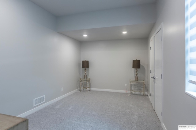 unfurnished room featuring a healthy amount of sunlight and light colored carpet