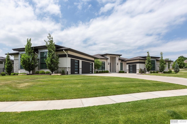 view of front of home with a garage and a front lawn