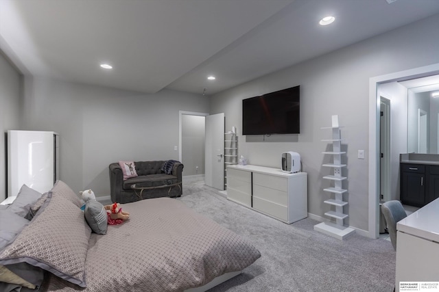 carpeted bedroom featuring connected bathroom