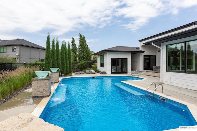 view of pool with pool water feature and a patio area