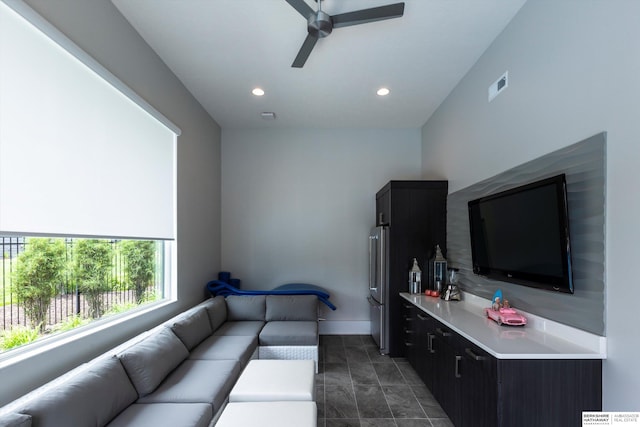 living room with ceiling fan and vaulted ceiling