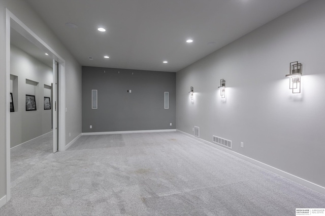 unfurnished room featuring light carpet