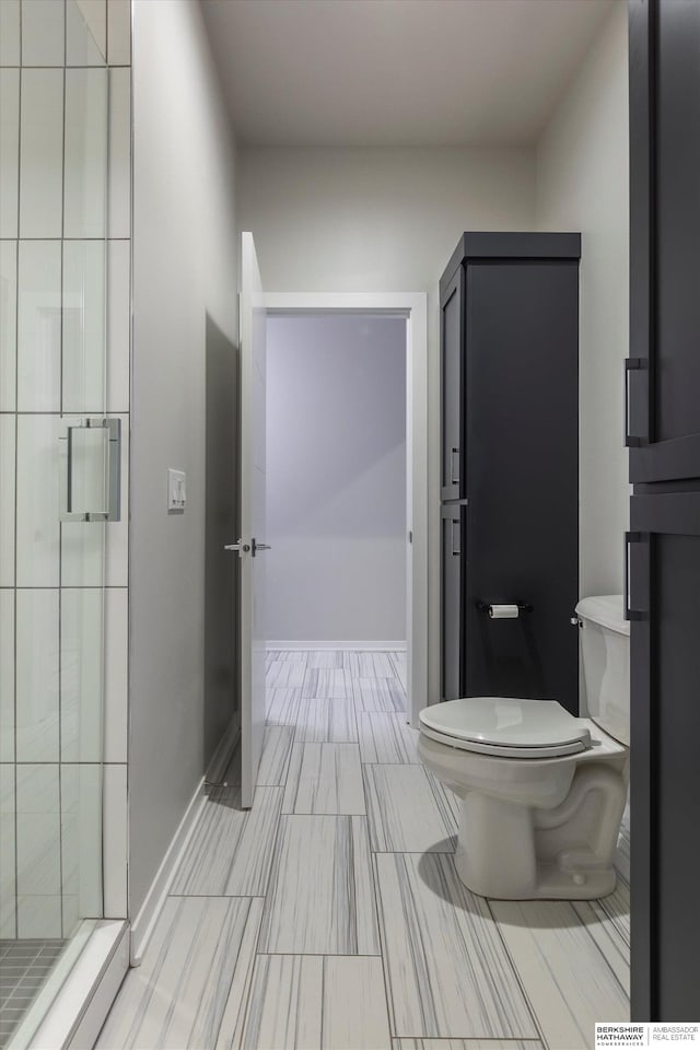 bathroom with walk in shower and toilet