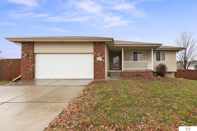 ranch-style home with a porch, a front yard, and a garage