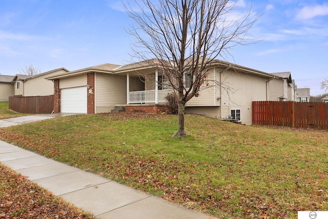 single story home with a front yard, a garage, and covered porch