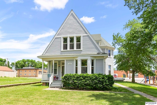 view of front of property with covered porch and a front lawn