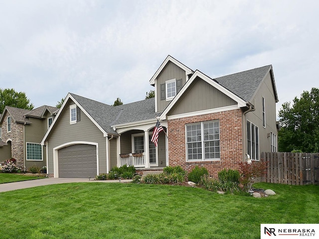 view of front of property with a garage, covered porch, and a front yard