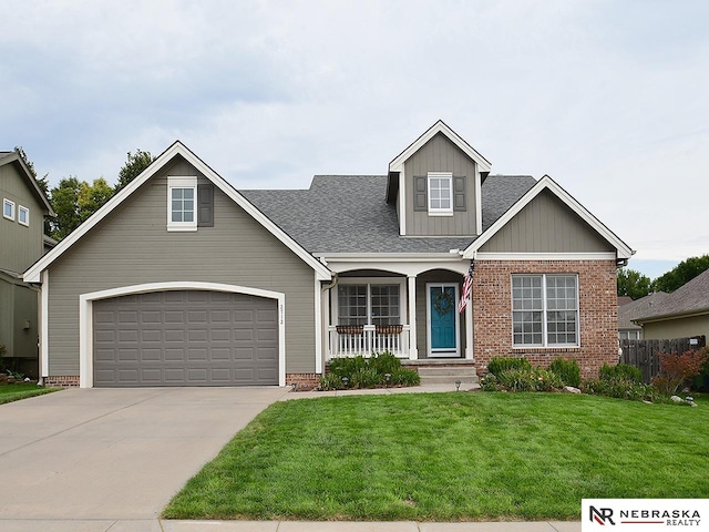 view of front of home featuring a front yard, a porch, and a garage