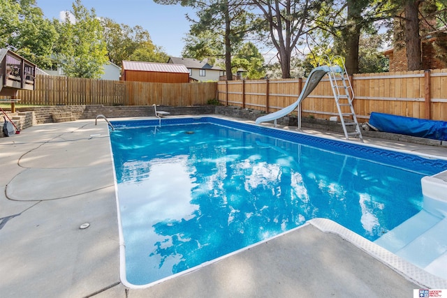 view of pool with a water slide