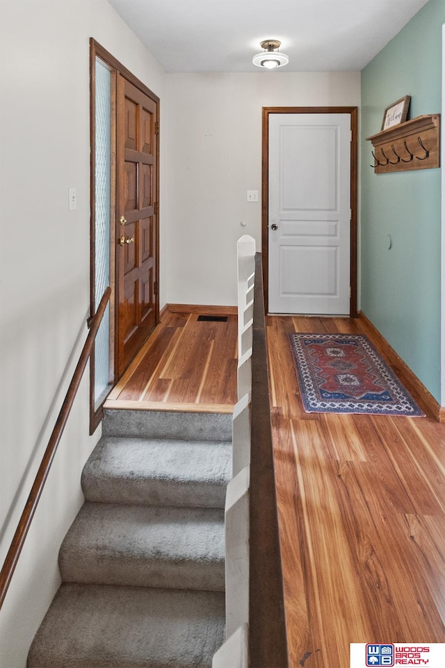 stairs featuring wood-type flooring